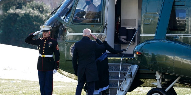 President Biden returns a salute as he and first lady Jill Biden board Marine One on the South Lawn of the White House, Friday, Jan. 7, 2022, in Washington. The Bidens were heading to Colorado and then Nevada.