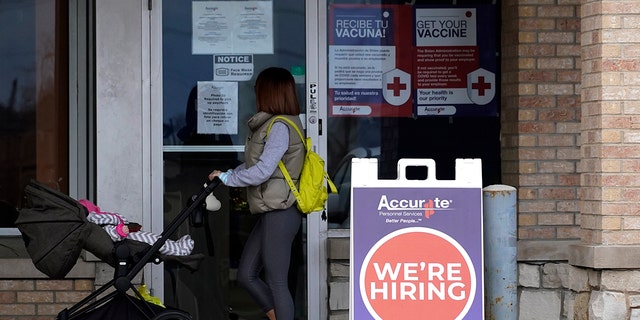A hiring sign is seen outside a Accurate Personnel employment agency office in Buffalo Grove, Illinois, Dec. 3, 2021.  One of the fastest years of job creation in U.S. history stumbled at the finish line in December. 