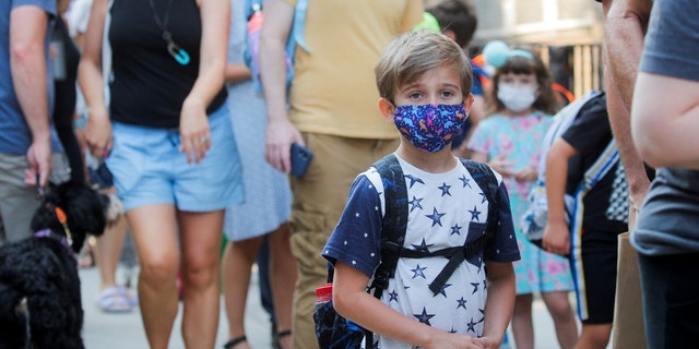 FILE – A child wears a face mask on the first day of New York City schools, amid the coronavirus disease (COVID-19) pandemic in Brooklyn, New York, U.S. September 13, 2021. REUTERS/Brendan McDermid/File Photo